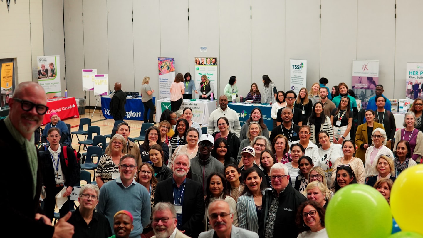 Un gruppo eterogeneo di persone si riunisce a un evento comunitario.